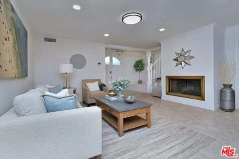 a living room with furniture flowerpot and a fireplace