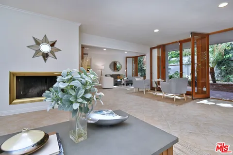 a dining room with furniture a chandelier and window