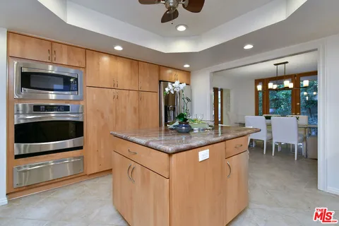 a living room filled with furniture and a large window