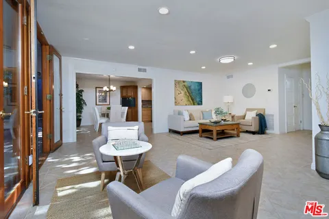 a living room with couches and a large window with outer view