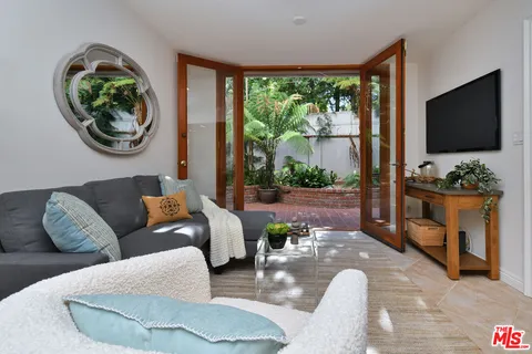 a view of a patio with couches and potted plants