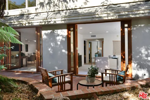 an outdoor space with patio and wooden fence