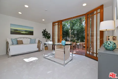 a view of backyard with seating area and trees