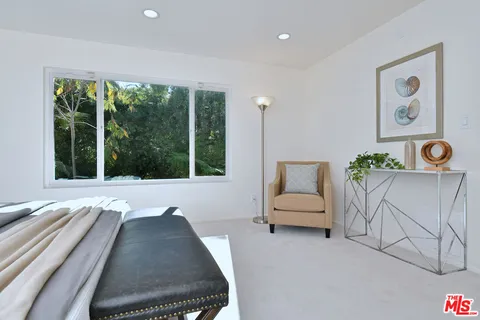 a bathroom with a tub a sink a mirror and a shower