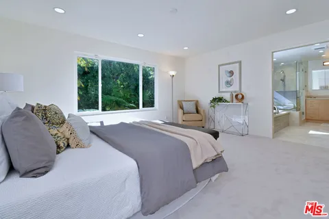 a living room with furniture and large windows