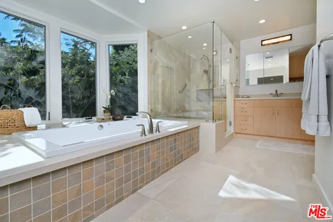 a bathroom with a double vanity sink mirror and