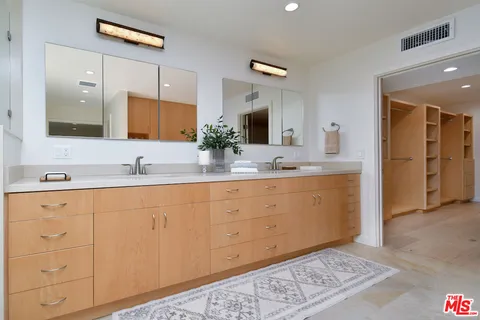 a kitchen with stainless steel appliances granite countertop a sink a stove and a refrigerator