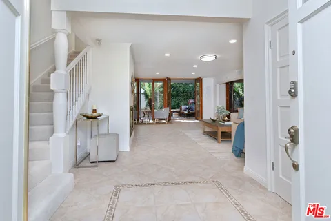 a view of an entryway with flower pots