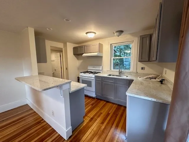 a kitchen with a sink stove and cabinets
