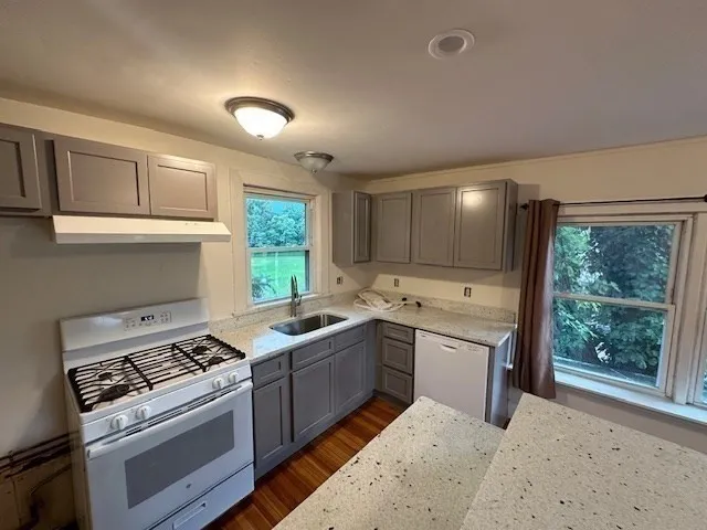 a kitchen that has a sink and a stove