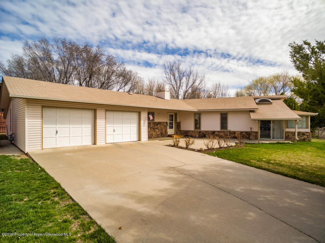 820 East 5th Street Rifle, CO 81650 - Photo 1 of 20 a front view of a house with yard and porch