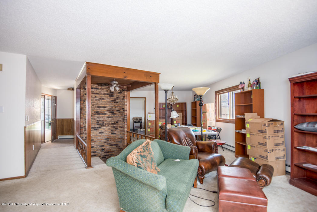 820 East 5th Street Rifle, CO 81650 - Photo 4 of 20 a living room with furniture and a floor to ceiling window
