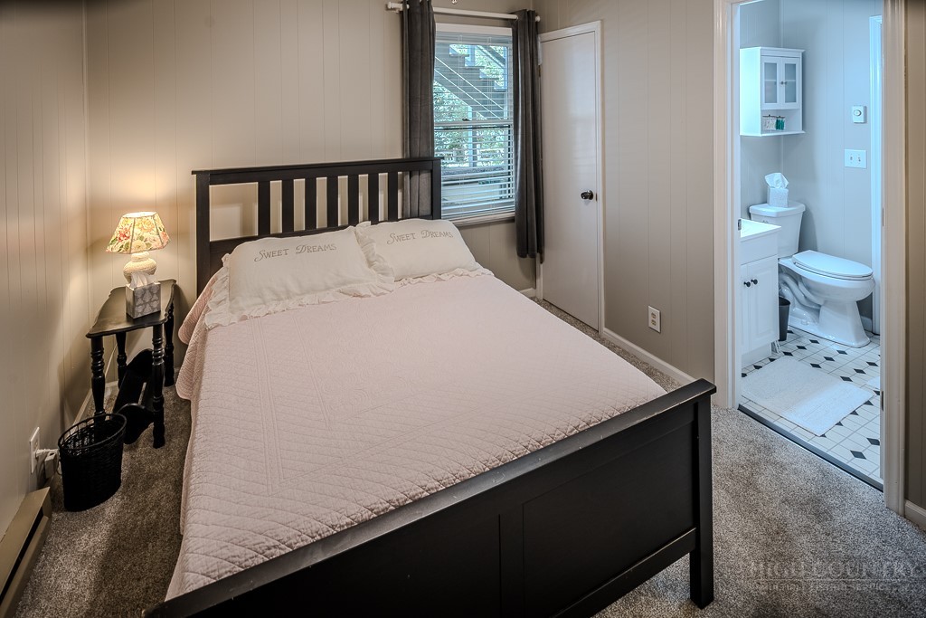 38 Rocky Meadows Road Newland, NC 28657 - Photo 28 of 50 a bed sitting in a bedroom next to a window