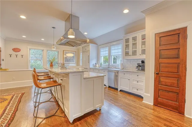 a view of a kitchen with furniture and wooden floor