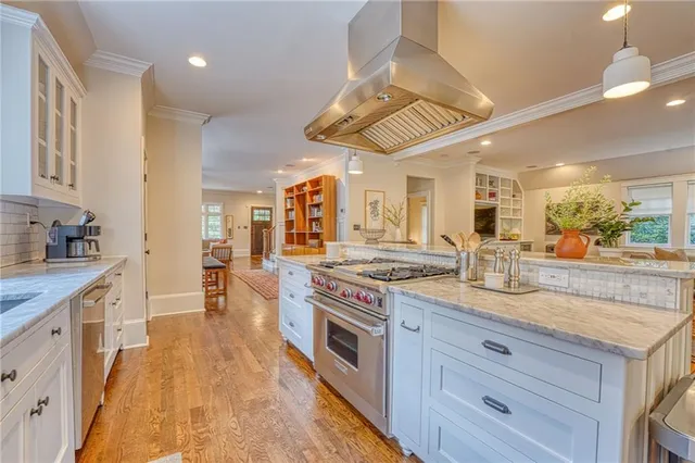 a kitchen with stainless steel appliances granite countertop a stove and a sink