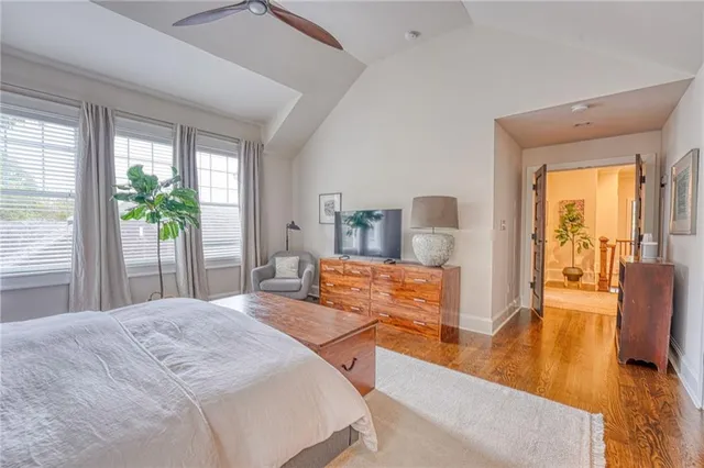 a bedroom with furniture and a large window