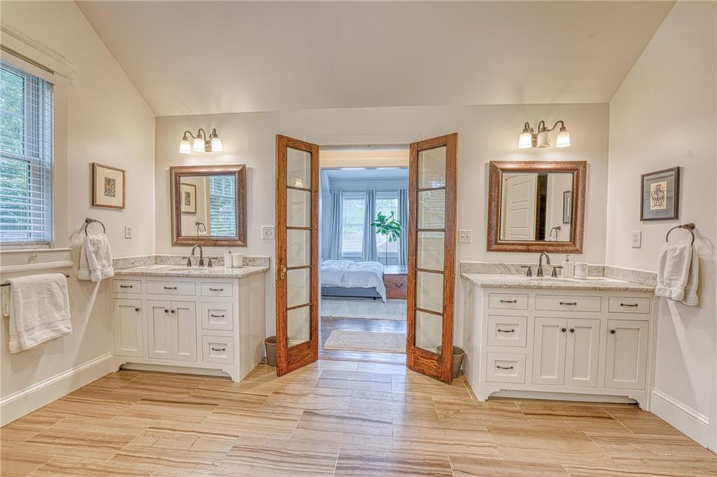 997 Blue Ridge Avenue Northeast Atlanta, GA 30306 - Photo 30 of 53 a spacious bathroom with a double vanity sink a mirror and a