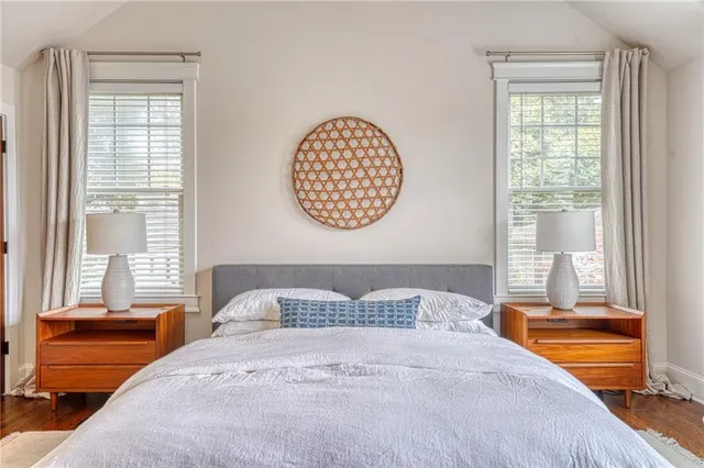 a bedroom with a large bed and a window