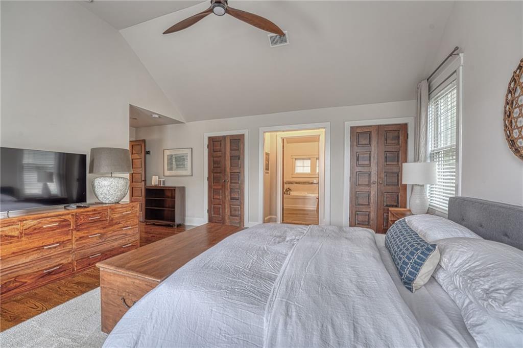 997 Blue Ridge Avenue Northeast Atlanta, GA 30306 - Photo 33 of 53 a spacious bedroom with a large bed a flat tv screen and dresser