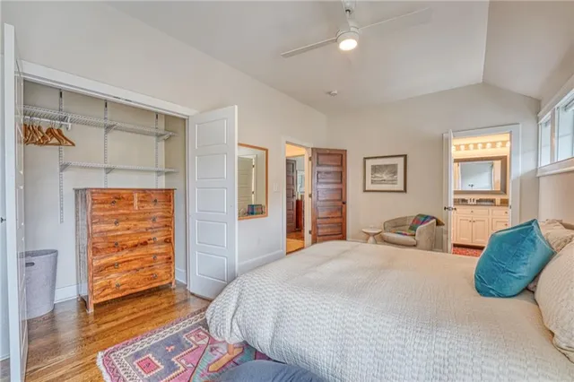 a bathroom with a granite countertop sink a toilet a mirror and shower