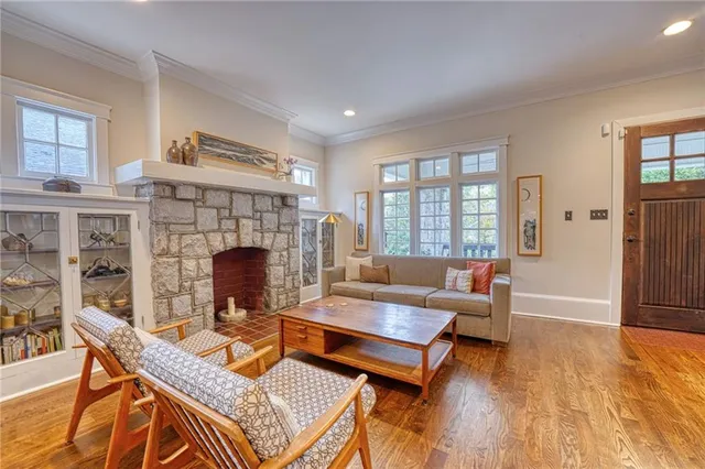 a living room with furniture a fireplace and a table