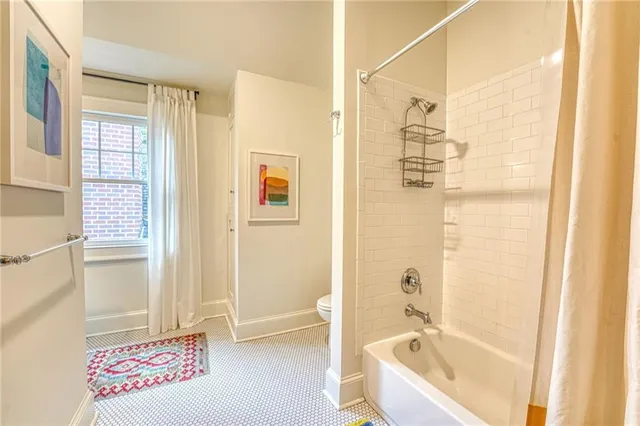 a bathroom with a toilet and a shower