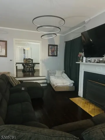 a kitchen with a table chairs and a flat screen tv