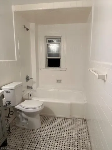 a bathroom with a toilet a sink and bathtub
