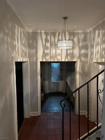 a view of a room with wooden floor and staircase