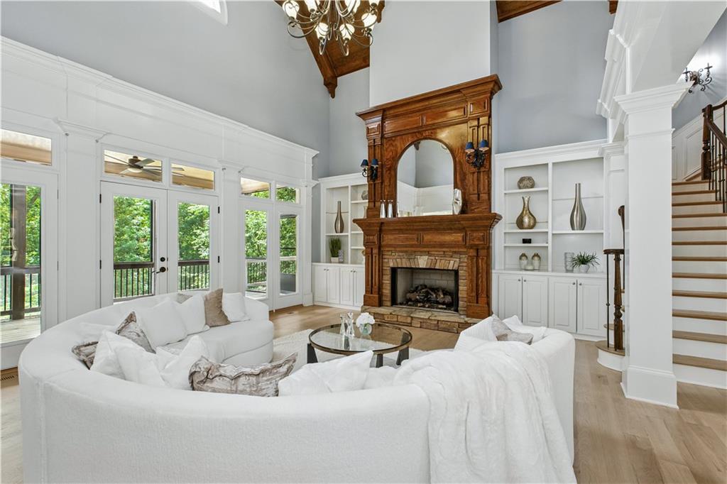 6225 Random Winds Bluff Gainesville, GA 30506 - Photo 14 of 96 a living room with furniture a fireplace and a large window