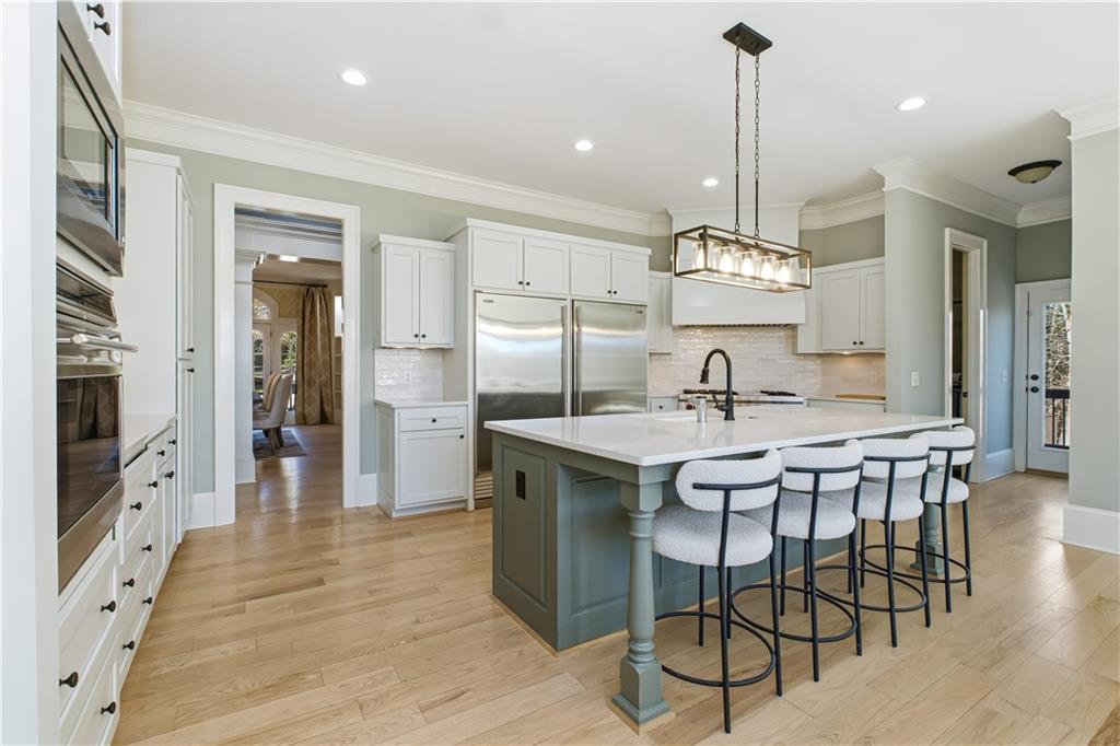6225 Random Winds Bluff Gainesville, GA 30506 - Photo 16 of 96 a kitchen with stainless steel appliances kitchen island a chandelier