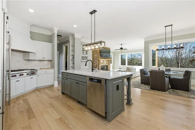 a dining room with furniture a fireplace and wooden floor