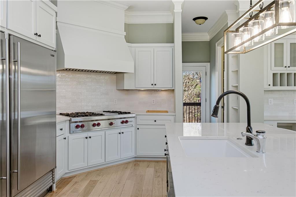 6225 Random Winds Bluff Gainesville, GA 30506 - Photo 18 of 96 a kitchen with stainless steel appliances granite countertop a stove a refrigerator and a sink