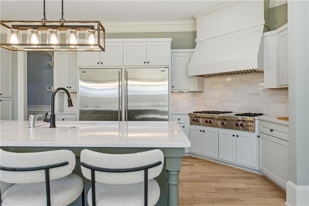 6225 Random Winds Bluff Gainesville, GA 30506 - Photo 22 of 96 a kitchen with stainless steel appliances a sink a stove and a wooden floors