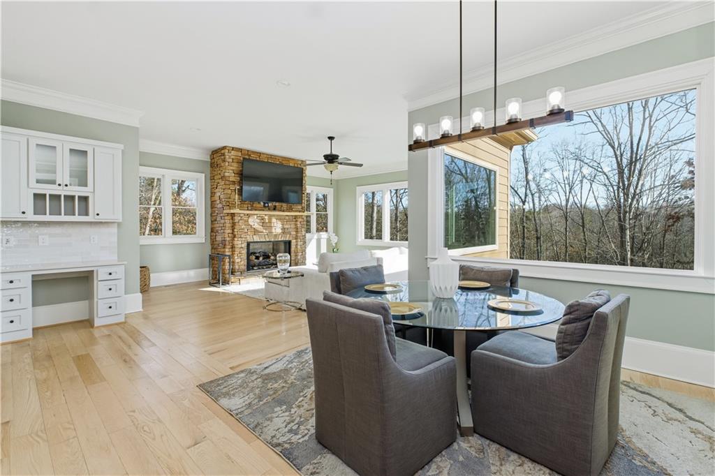 6225 Random Winds Bluff Gainesville, GA 30506 - Photo 27 of 96 a dining room with furniture a fireplace and wooden floor