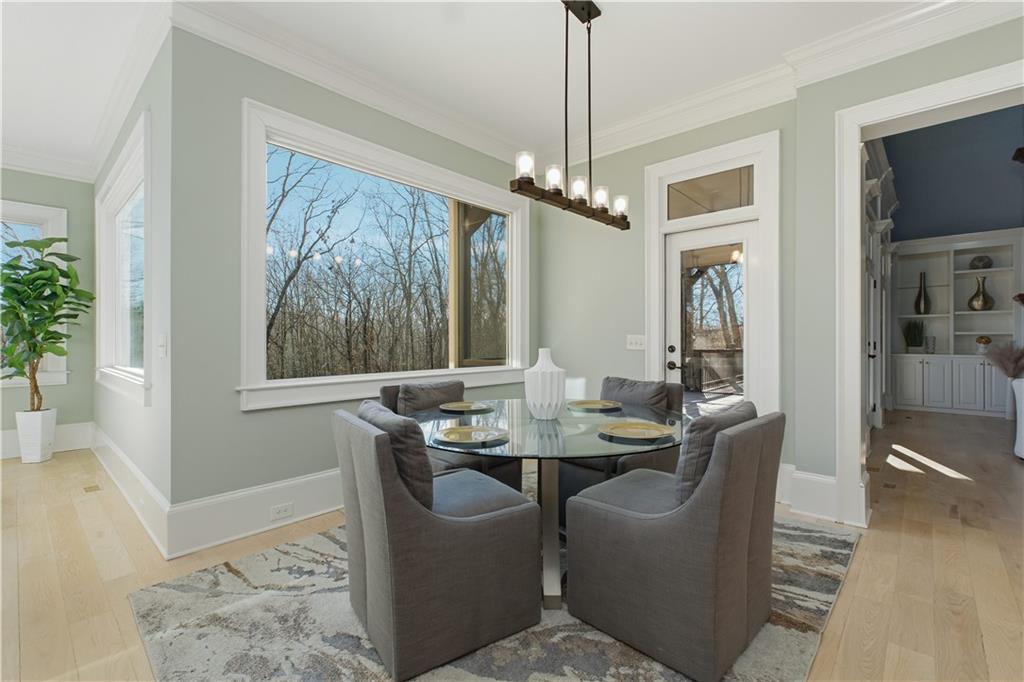 6225 Random Winds Bluff Gainesville, GA 30506 - Photo 28 of 96 a dining room with furniture a chandelier and wooden floor