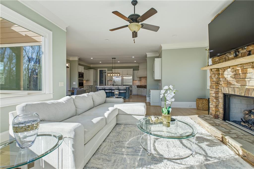 6225 Random Winds Bluff Gainesville, GA 30506 - Photo 33 of 96 a living room with furniture a fireplace and a flat screen tv
