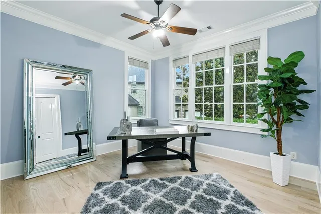 a bedroom with a bed and a chandelier fan