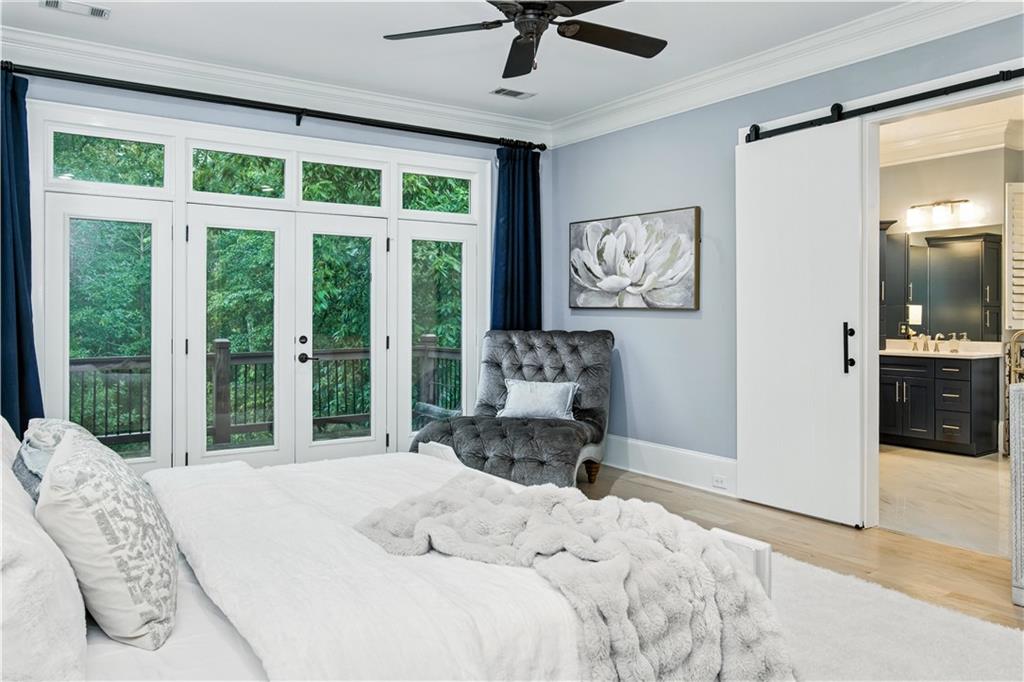 6225 Random Winds Bluff Gainesville, GA 30506 - Photo 38 of 96 a bedroom with a bed and glass windows