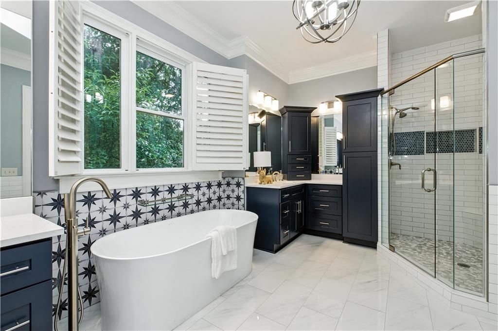 6225 Random Winds Bluff Gainesville, GA 30506 - Photo 41 of 96 a bathroom with a tub a sink a mirror and a shower