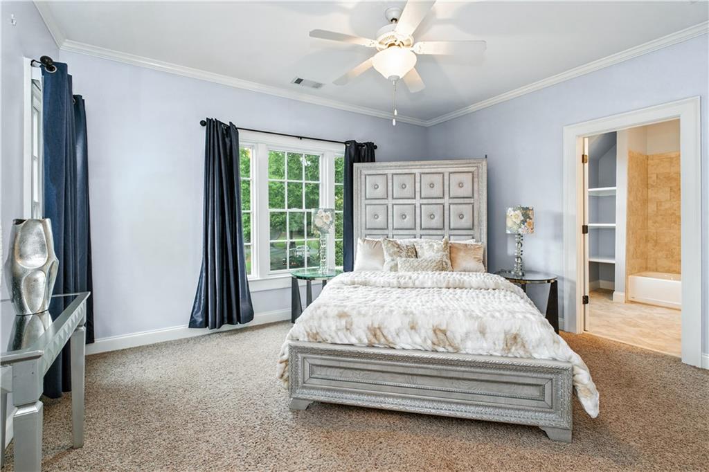 6225 Random Winds Bluff Gainesville, GA 30506 - Photo 43 of 96 a spacious bedroom with a bed and a large window