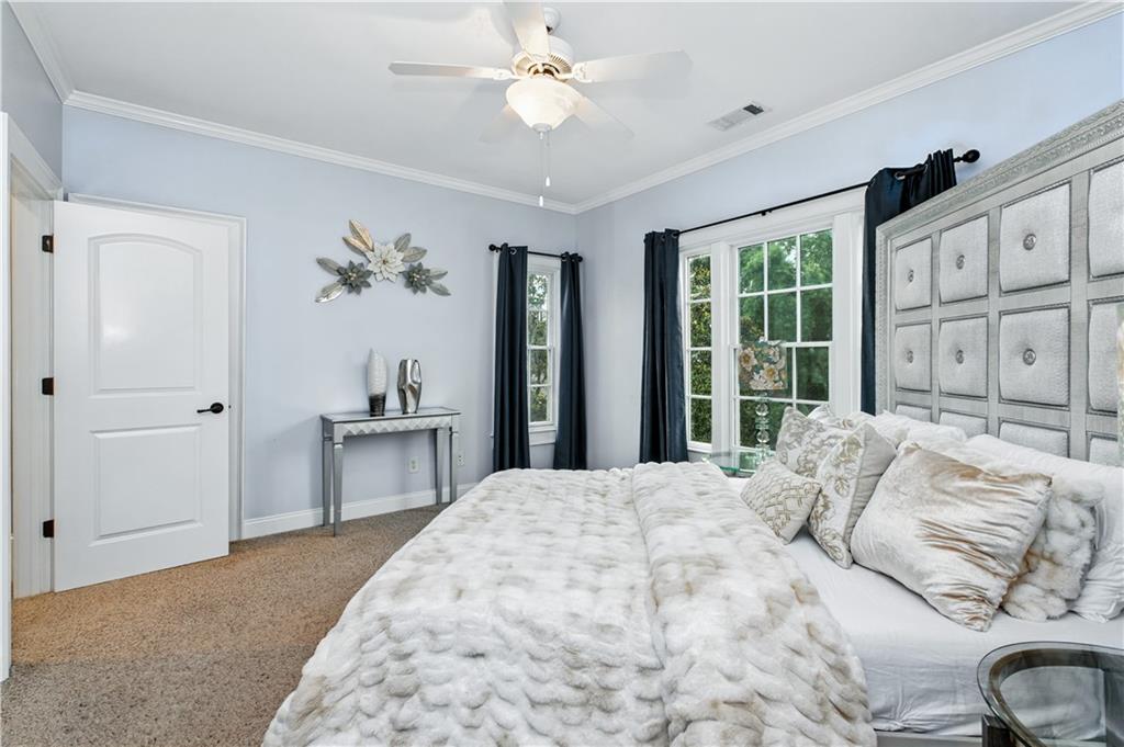 6225 Random Winds Bluff Gainesville, GA 30506 - Photo 44 of 96 a bedroom with a large bed and a chandelier