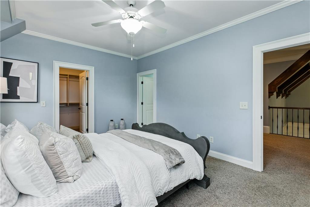 6225 Random Winds Bluff Gainesville, GA 30506 - Photo 48 of 96 a bedroom with a bed and a chandelier