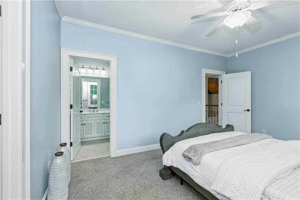 6225 Random Winds Bluff Gainesville, GA 30506 - Photo 49 of 96 a bedroom with a bed and a chandelier fan