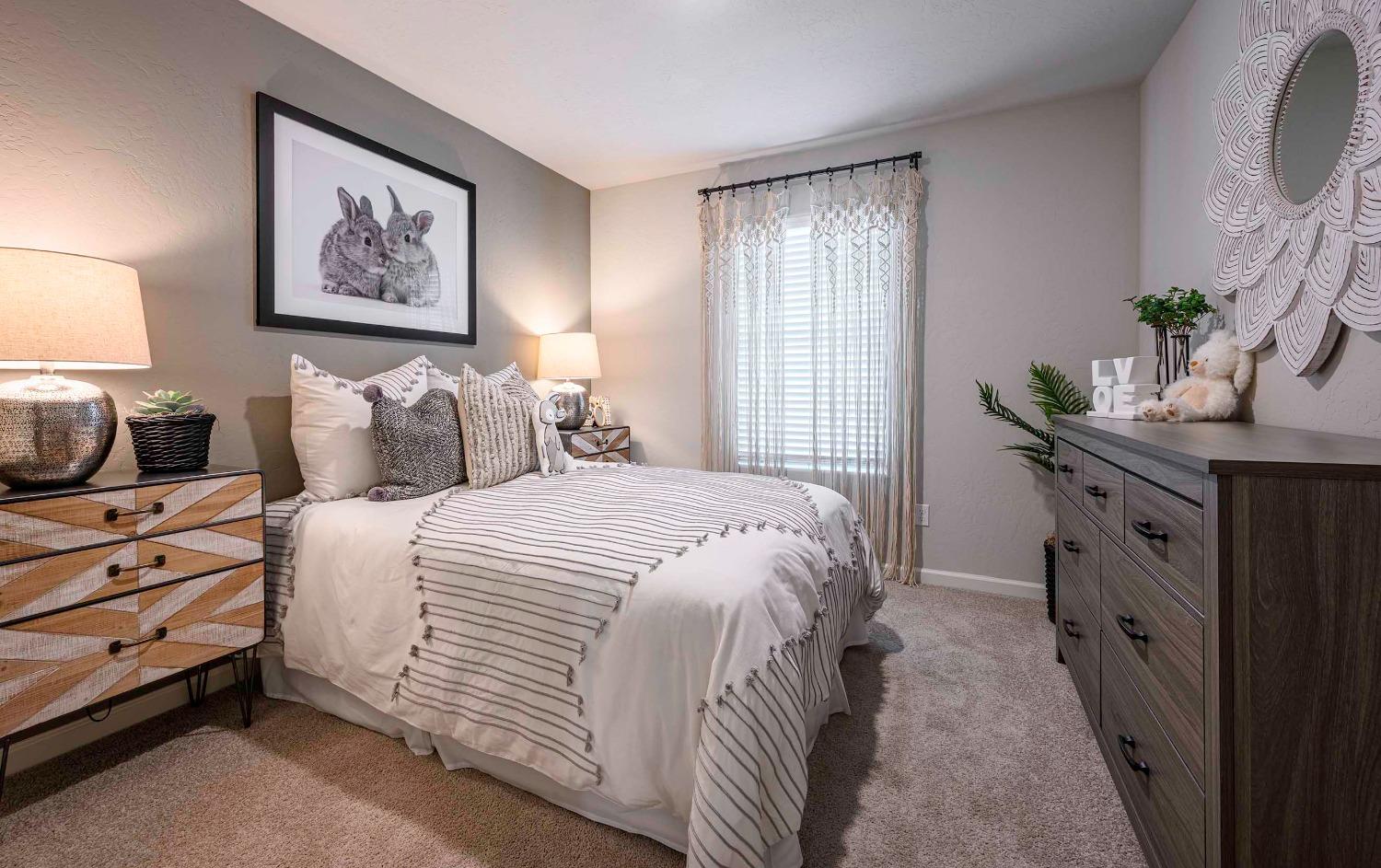 1553 Seneca Drive, Unit 86 Madera, CA 93637 - Photo 17 of 21 a bedroom with a bed and a lamp on dresser