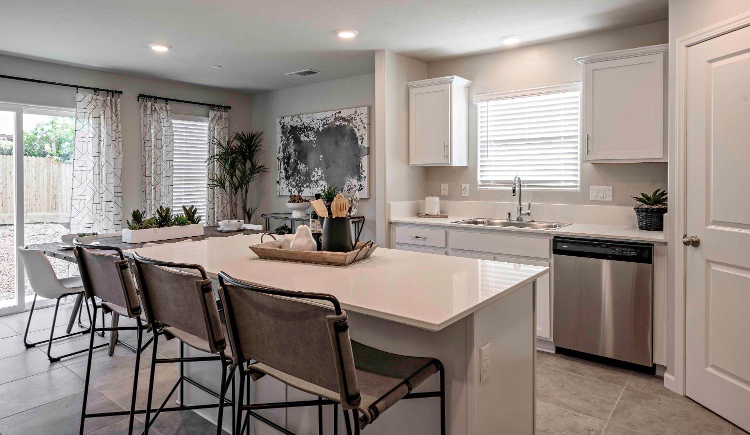 1553 Seneca Drive, Unit 86 Madera, CA 93637 - Photo 3 of 21 a kitchen with a table chairs sink and cabinets