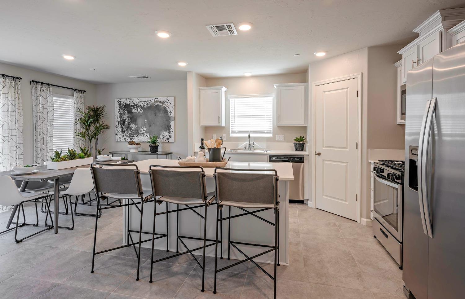 1553 Seneca Drive, Unit 86 Madera, CA 93637 - Photo 5 of 21 a kitchen with a table chairs refrigerator and microwave