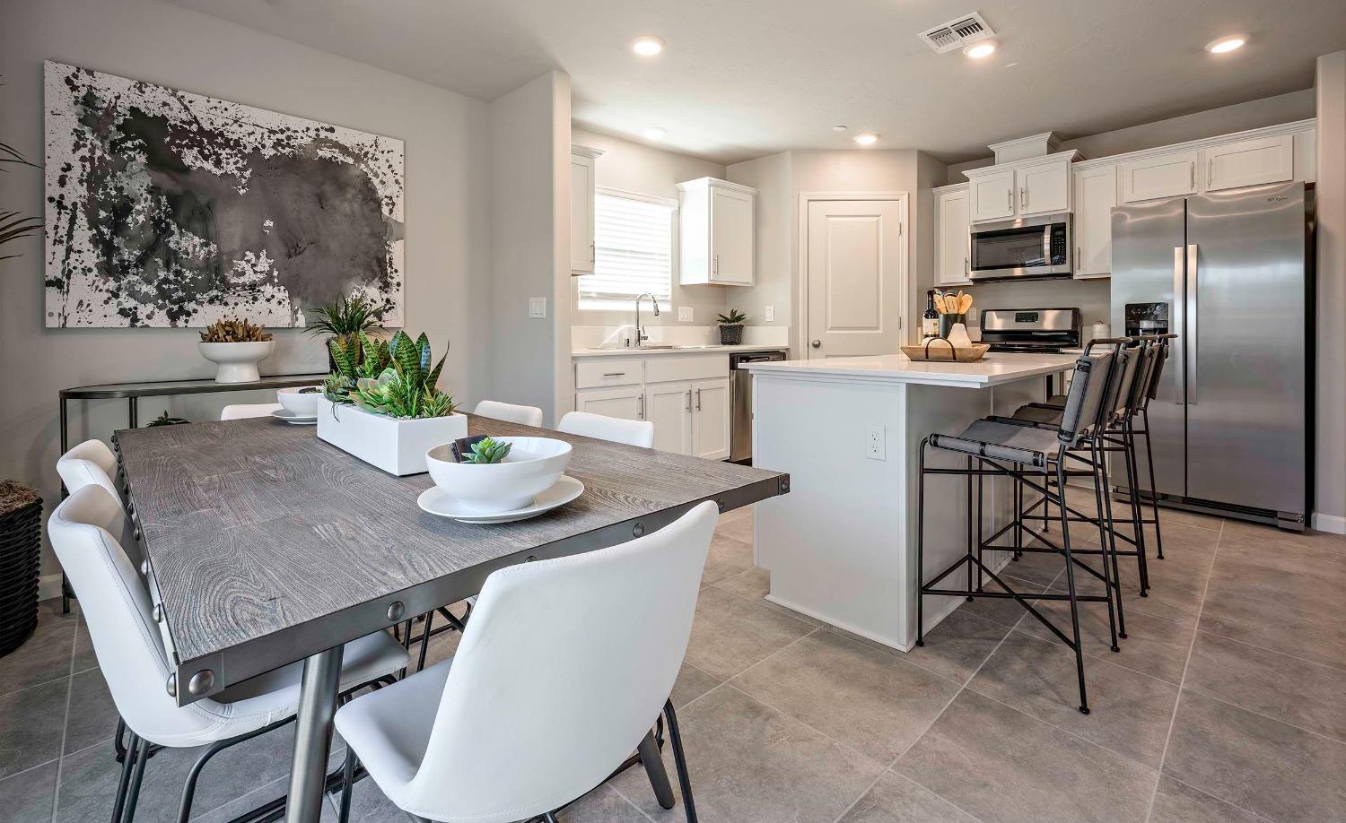 1553 Seneca Drive, Unit 86 Madera, CA 93637 - Photo 6 of 21 a kitchen with a table chairs refrigerator and microwave