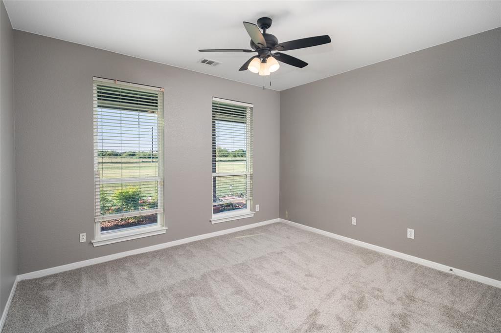 1019 Vaughan Lane Tioga, TX 76271 - Photo 26 of 40 Spacious room featuring neutral grey wall paint and light grey carpeting