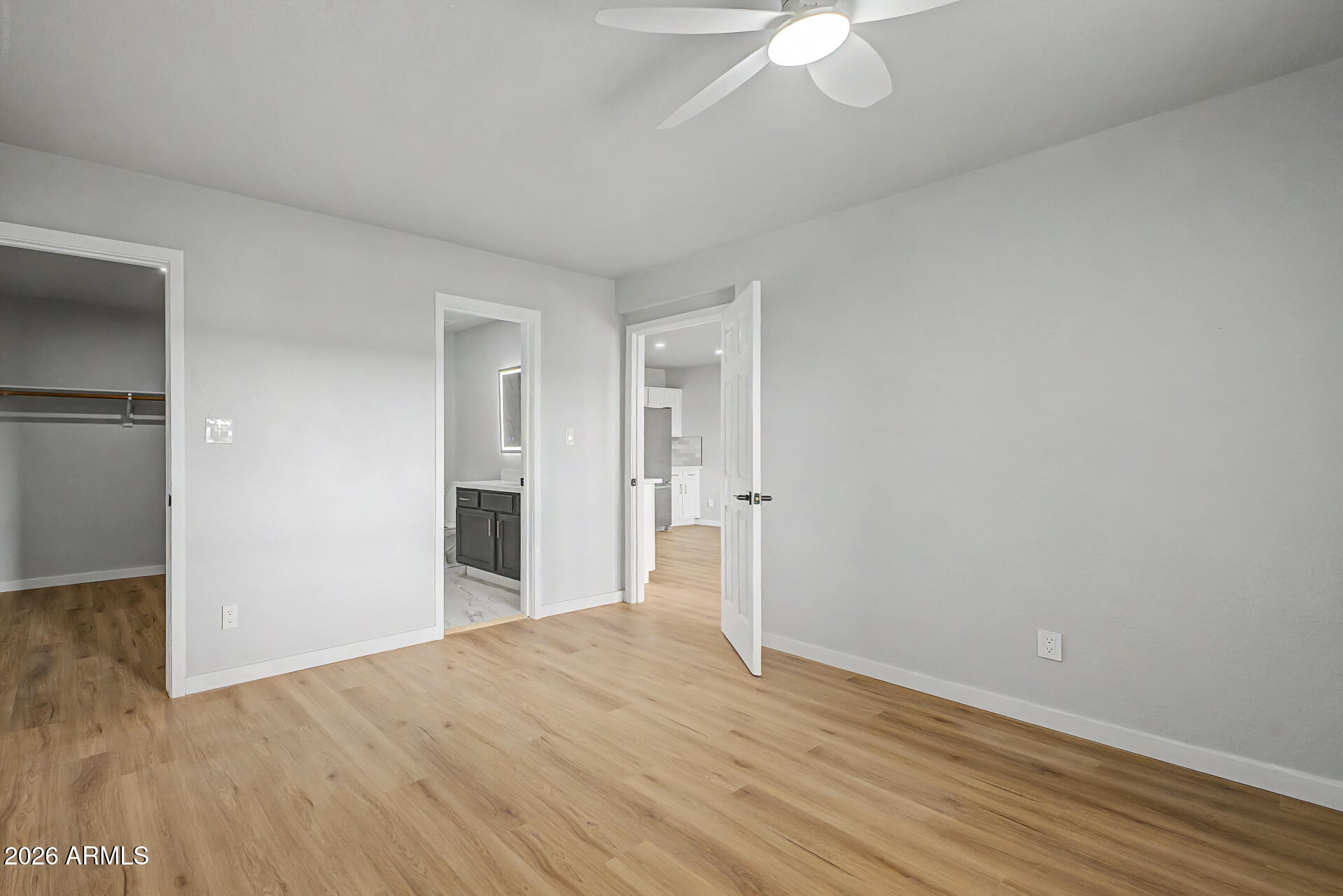 1440 North Idaho Road, Unit 1060 Apache Junction, AZ 85119 - Photo 14 of 16 a view of an empty room with wooden floor